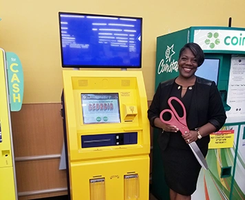 Commissioner Washington standing next to tag kiosk